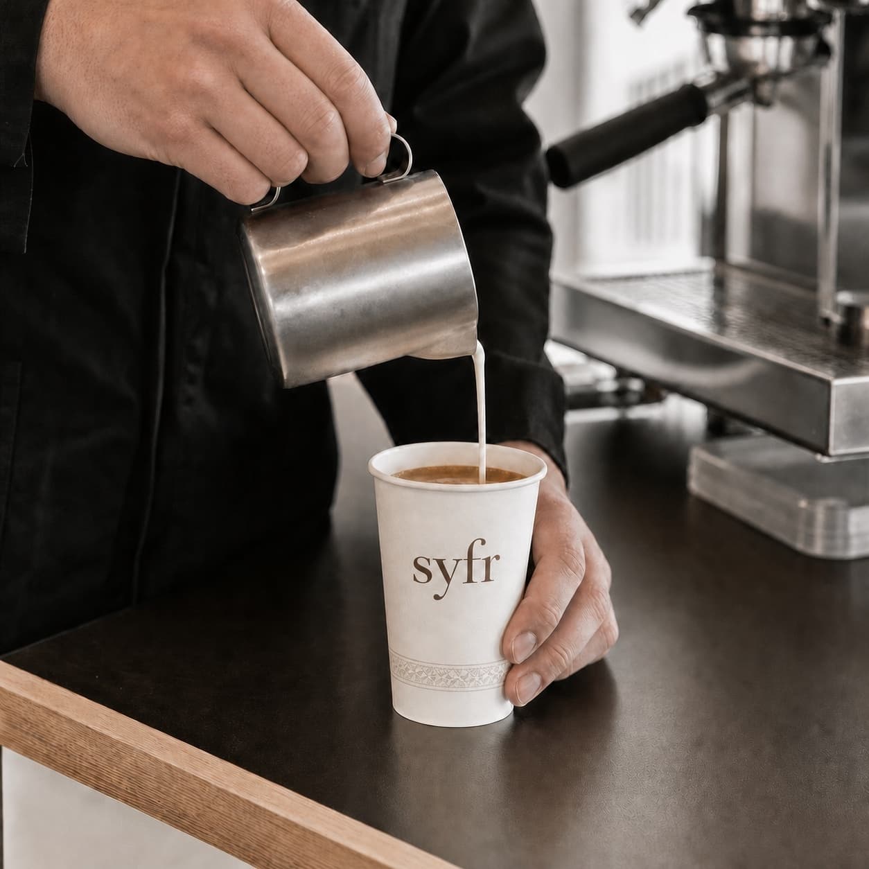 Milk poured into a branded Syfr cup